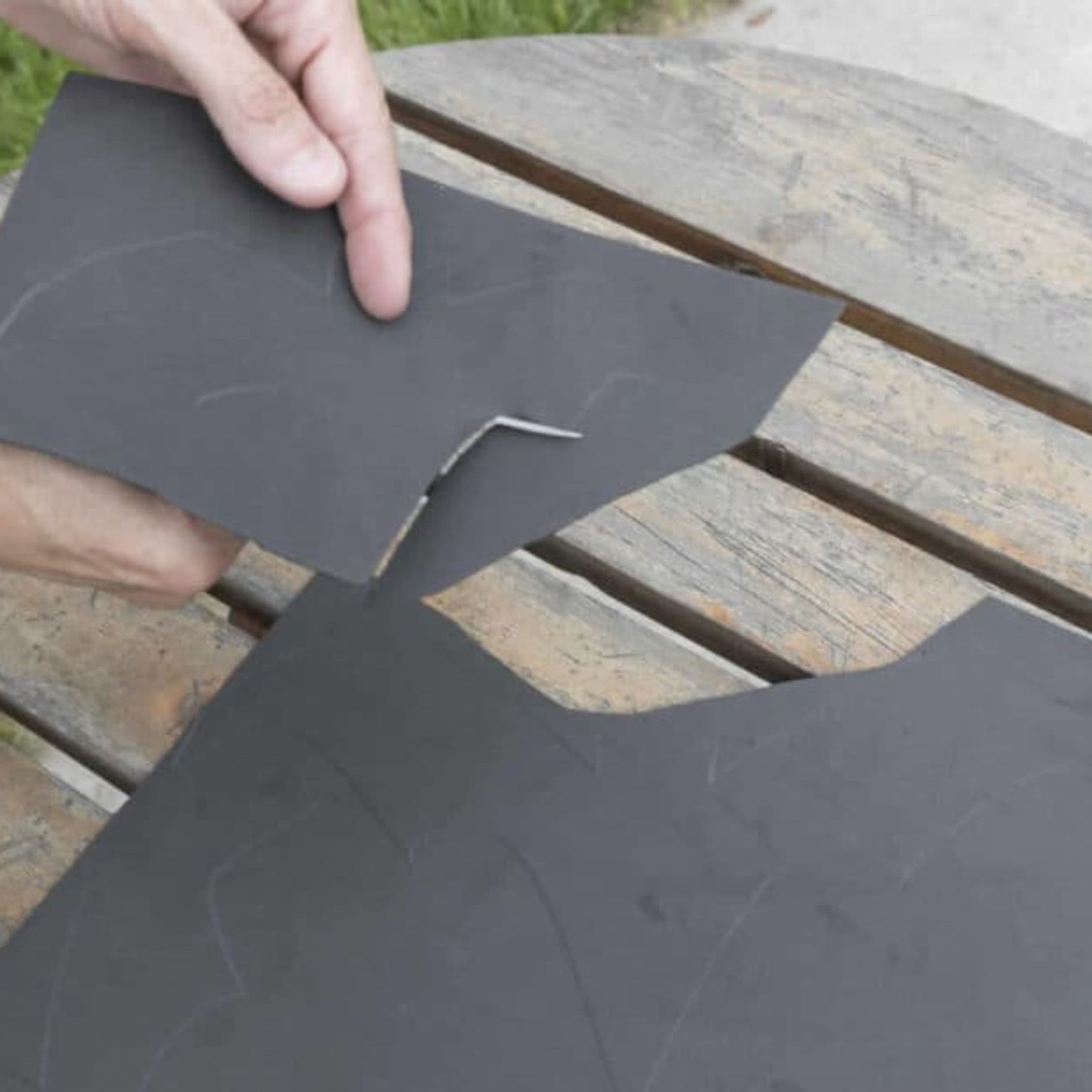 Serena cuts out black bat shapes from her foam sheet.