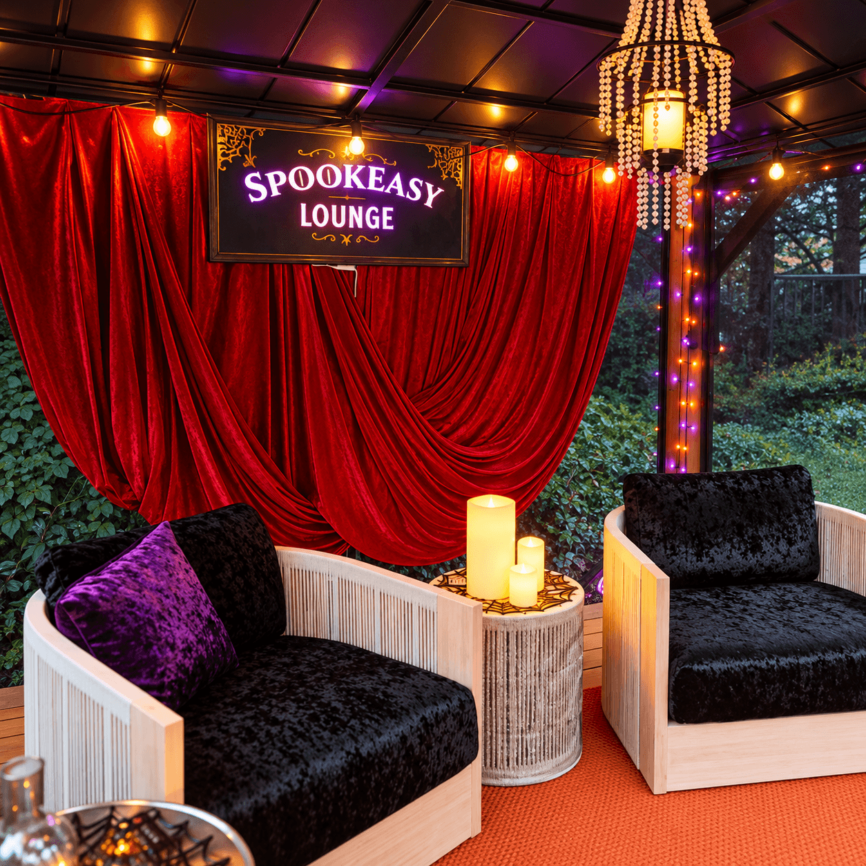 Close-up of the Spookeasy Lounge seating area with black velvet chairs, red curtains, glowing candles, and Halloween string lights.