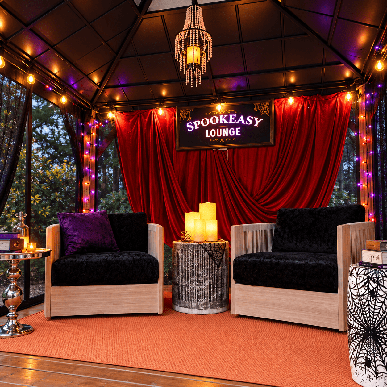 Finished Spookeasy Lounge Halloween makeover featuring red velvet drapes, black lounge chairs, purple lighting, and an illuminated sign.
