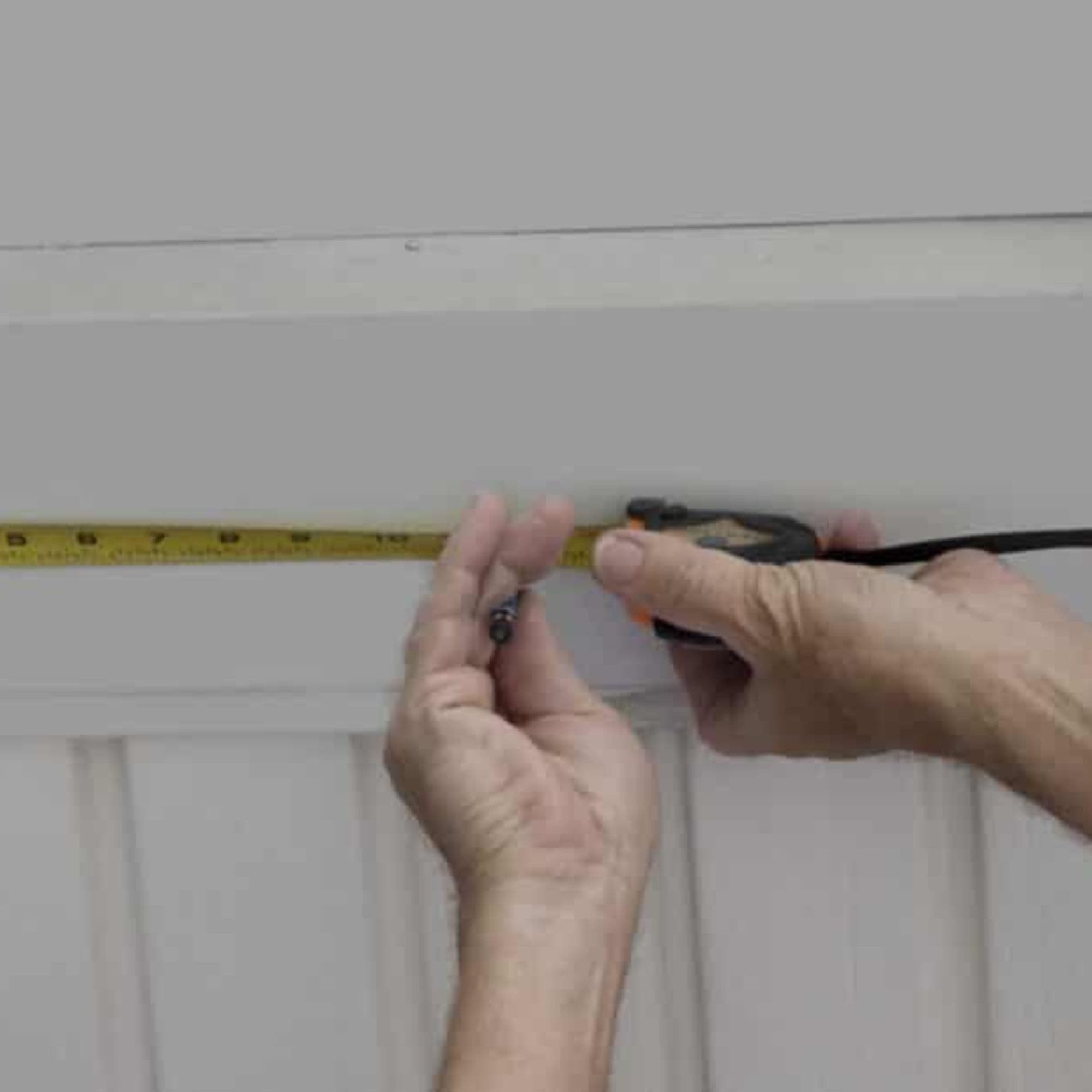Serena measures 12" on her porch roof using a tape measure.